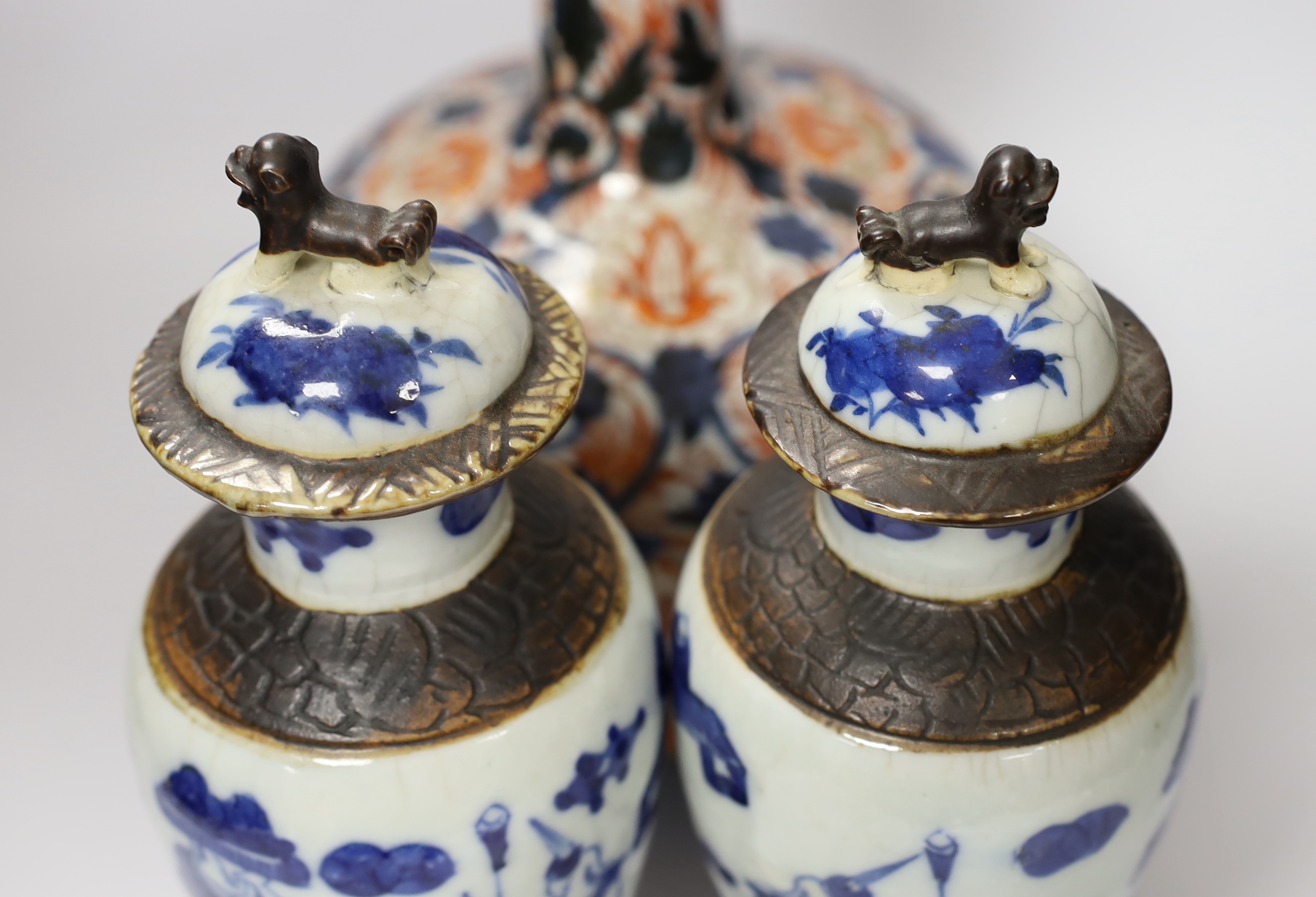 A pair of Chinese blue and white crackleware vases and covers and an Imari vase and cover, largest 31cm high